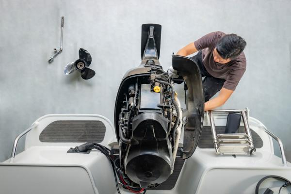 Service Technician working on a boat at Kawagama Lake Marina Dorset Haliburton